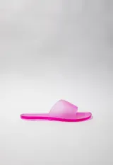 Sandalia chata fucsia de goma semi transparente con tira ancha sobre el empeine.