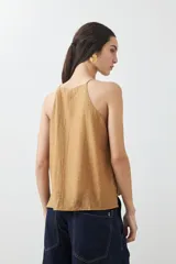 Top tostado sin mangas con cuello halter y brillos.