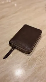 Billetera de cuero de pelo con estampado animal print de leopardo. Cuenta con cierre perimetral y una etiqueta de cuero con el logo de la marca grabado.