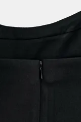 Vestido corto de corte ajustado con escote tipo bustier y tirantes finos. Presenta costuras verticales que definen la silueta y cierre posterior con cremallera oculta.