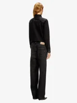 Overall de trabajo de denim negro lavado, con camisa de manga larga abotonada y pantalón de corte recto.