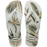 Ojotas Havaianas con estampado de hojas en tonos beige, marrón y negro sobre base blanca. Tiras blancas con logo de la marca en relieve.