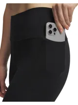 Calza deportiva de tiro alto con bolsillos laterales, confeccionada en tejido elástico de alto rendimiento con tecnología que absorbe el sudor y se seca rápidamente.