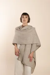 Ruana de lana fina sin teñir, con textura acanalada y terminaciones tejidas a crochet hechas a mano.