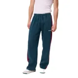 Pantalon de jogging Rusty, color verde petróleo con franjas laterales en color bordó. Presenta cintura elástica con cordón ajustable y logo de la marca bordado en la pierna.