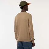 Sweater de punto con textura fantasía, cuello redondo y mangas largas con puños acanalados.