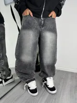 Pantalón de corte baggy en denim gris con efecto lavado y detalle de pequeñas incrustaciones de strass distribuidas por toda la prenda.