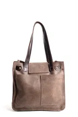 Cartera tipo tote de cuero color beige con diseño de flecos en la solapa frontal. Cuenta con manijas de cuero oscuro, cierre metálico tipo torniquete y detalles de herrajes dorados.