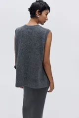 Chaleco de punto fino con lana, de corte holgado, cuello redondo y terminaciones acanaladas en cuello, sisas y bajo.