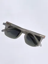 Lentes de sol marca Osten modelo Tokyo, con armazón de acetato en tono verde oliva mate y cristales oscuros polarizados. Presentan un diseño de marco completo con detalle de logo grabado en la patilla.