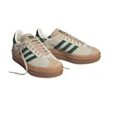 Championes Adidas modelo Gazelle Bold con diseño de plataforma apilada en color caramelo. Confeccionados en gamuza color crema con las icónicas tres tiras laterales y refuerzo en el talón en color verde oscuro.