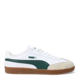 Championes Puma 9T blancos con detalles en verde y suela marrón.
