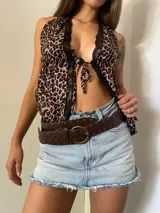 Top con estampado animal print, escote halter con encaje negro y lazo ajustable en el frente.