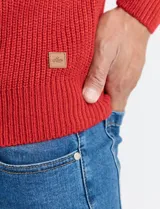 Sweater de punto inglés color verde, con cuello alto y cierre frontal parcial metálico. Diseño de manga larga con puños y ruedo acanalados.