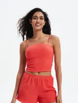 Musculosa de textura fruncida con breteles finos y escote recto, de corte ajustado al cuerpo.