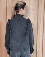 Camisa de denim negro con cuello alto, cierre frontal de botones y detalles de volados en el frente y puños.