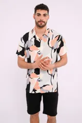 Camisa de manga corta con cuello clásico y estampado abstracto en tonos blanco, negro, gris y naranja.