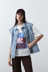 Remera de manga corta con corte boxy fit, color blanco, con estampa frontal geométrica en tonos azul, rosado y marrón.