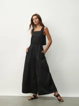 Mono negro con escote cuadrado, sin mangas, corte holgado y cintura elastizada.