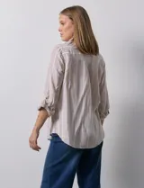 Camisa de lino marca Dash, color beige con rayas verticales blancas, cuello con solapa, cierre frontal de botones, bolsillo aplicado en el pecho y mangas largas con sistema para arremangar mediante presilla y botón.
