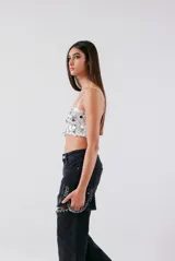 Top corto color blanco con lentejuelas y tirantes finos.