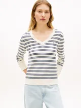 Sweater de punto de puro algodón orgánico con diseño a rayas horizontales en color blanco, azul marino y celeste. Presenta cuello en V, mangas largas con puños acanalados y el logo bordado de Tommy Hilfiger en el pecho.
