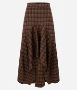 Pollera midi de sastrería con estampa de cuadros en tonos marrones. Posee diseño mullet, más corta al frente y alargada atrás, cintura alta y recortes que aportan movimiento.