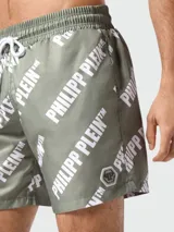 Short de baño verde con estampado del logo de la marca en color blanco.