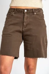 Bermuda de denim color marrón, de tiro medio y corte midi, con bolsillos laterales y terminaciones desmechadas en las piernas.