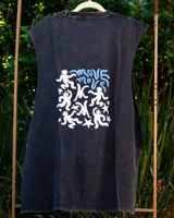 Musculosa sin mangas color naranja quemado, con cuello redondo y sisas amplias. Estampado frontal en blanco con figuras estilizadas y texto.