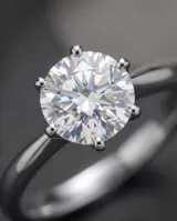Anillo solitario de acero con piedra circonia central de corte redondo engarzada con seis puntas.