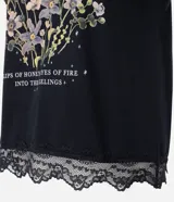 Blusa muscle de algodón negro con hombros estructurados y estampa frontal 'Feminine Mystique' con motivos florales, luna y mariposa.