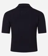 Polo de manga corta color azul marino, confeccionado en punto acanalado, con cuello polo y tapeta de tres botones. Presenta un bolsillo de parche en el lado izquierdo del pecho.