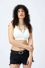 Top blanco sin costuras, de breteles finos y terminación acanalada.