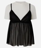 Remera baby tee de algodón con superposición de musculosa transparente de tul negro con breteles finos y escote en V.