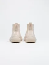 Zapatilla tipo bota color beige, con puntera dividida y confeccionada en tejido Tencel.