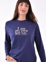 Remera de manga larga color beige, con cuello redondo y estampado frontal que dice "Magic is something you make" en color lila.