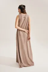 Maxi vestido negro sin mangas, con cuello redondo y silueta suelta que se abre en A hacia el ruedo. Confeccionado en 100% algodón, incluye aplique trasero en forma de X.