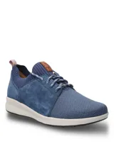 Championes casuales Hush Puppies modelo Spinal Knit, color azul marino. Presentan una combinación de tejido técnico transpirable en la puntera y laterales de cuero gamuzado. Incluyen cordones jaspeados, cuello tejido elástico y suela ergonómica de color blanco con tecnología Spinal para soporte postural.