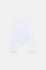 Camiseta de cuello barco y manga larga con diseño asimétrico en el bajo. Presenta un corte entallado con cierre lateral mediante cremallera oculta.