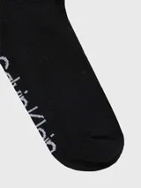 Pack de tres pares de medias tobilleras de punto, color negro, con el logo de Calvin Klein estampado en blanco alrededor del tobillo y las iniciales 'CK' en la parte superior.