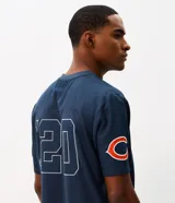 Remera deportiva de manga corta color azul marino, con cuello en V y estampa frontal de los Chicago Bears con numeración en tono blanco. Confeccionada en poliéster con tecnología dry de secado rápido.