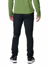 Pantalón de senderismo Columbia modelo Triple Canyon II, color negro, diseñado para actividades al aire libre. Cuenta con tecnología Omni-Shield que repele la humedad y manchas, y protección solar Omni-Shade UPF 50. Posee bolsillos con cremallera en laterales, manos y espalda, cintura cómoda y puños ajustables.