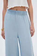 Pantalón celeste de lyocell, de corte ancho y tiro alto, con bolsillos laterales.