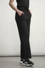 Pantalón deportivo de corte recto y tiro alto, con cintura elástica ajustable mediante cordón. Presenta aberturas laterales en el ruedo y bolsillos laterales.