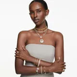 Brazalete rígido abierto bañado en rodio con dos flores de Swarovski Zirconia amarillas y transparentes.