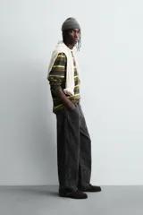 Pantalón de corte baggy fit confeccionado en tejido de algodón con textura y efecto lavado. Presenta diseño de cinco bolsillos, cierre frontal con cremallera y botón.