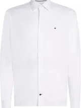 Camisa de manga larga Tommy Hilfiger confeccionada en algodón regenerativo con tejido de sarga. Presenta cuello camisero clásico, cierre frontal con botones y logo de la marca bordado en el pecho.