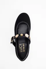 Ballerina de gamuza negra con punta redondeada, tira sobre el empeine con hebilla dorada y detalle decorativo de strass.