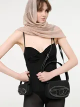 Mono negro de Diesel con corset y transparencias en las piernas. Breteles finos regulables y cierre en la espalda.